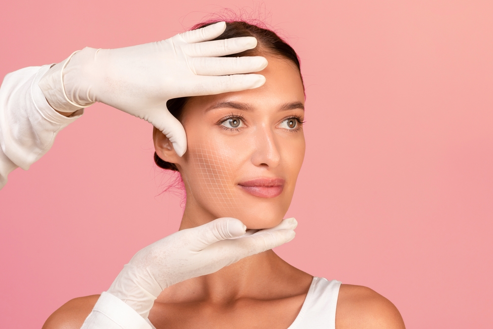 A provider examining a woman’s skin before a Morpheus8 microneedling treatment